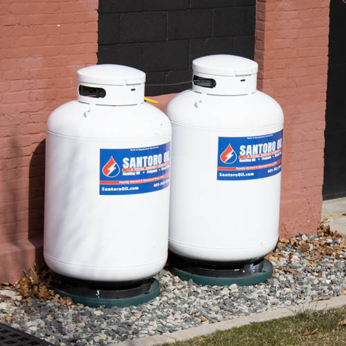 Santoro propane storage tanks outside a residential building